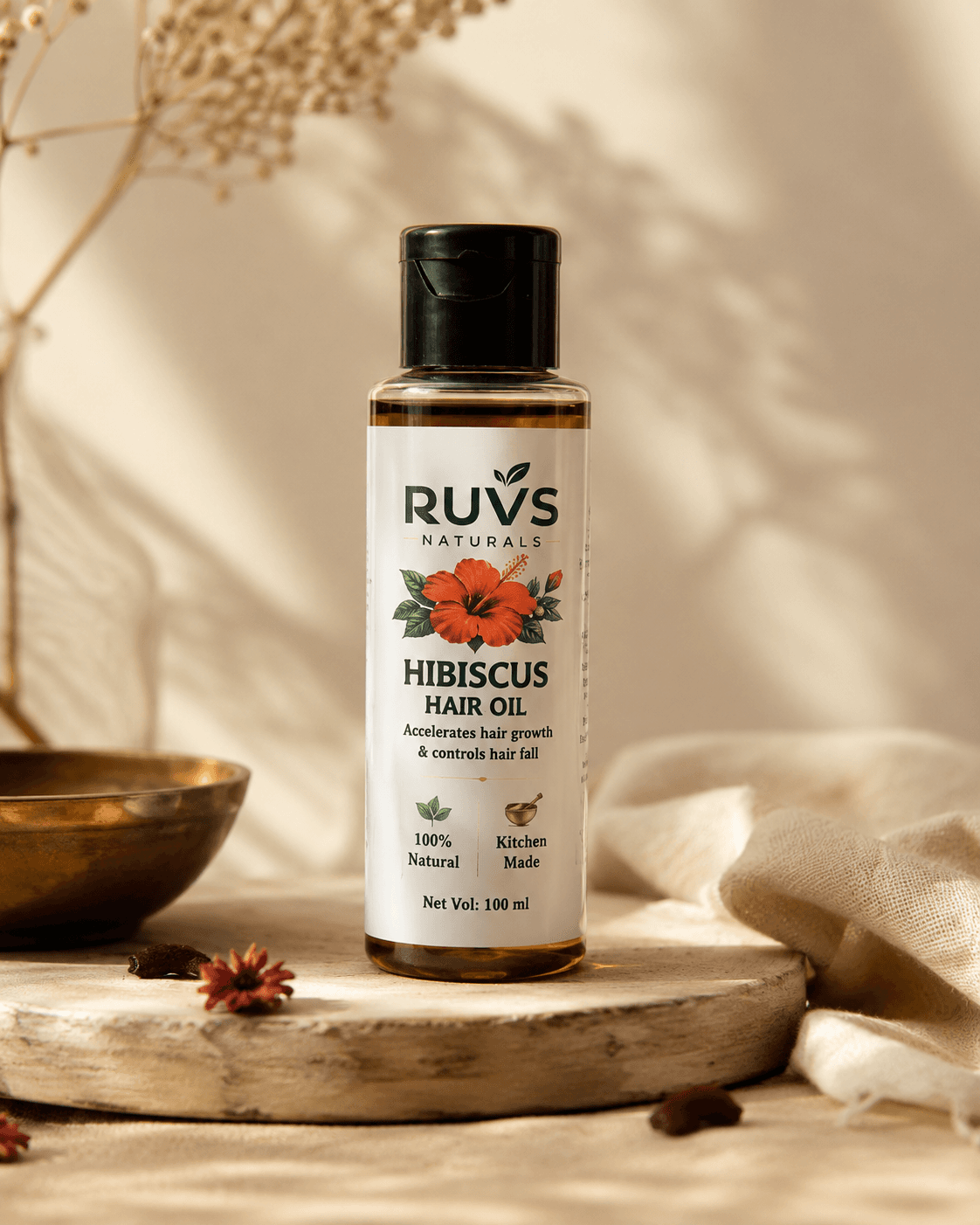 RUVS Naturals Hibiscus Hair Oil bottle on an earthy surface